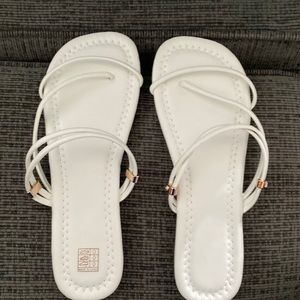White sandals. Never worn. Cute embellishments